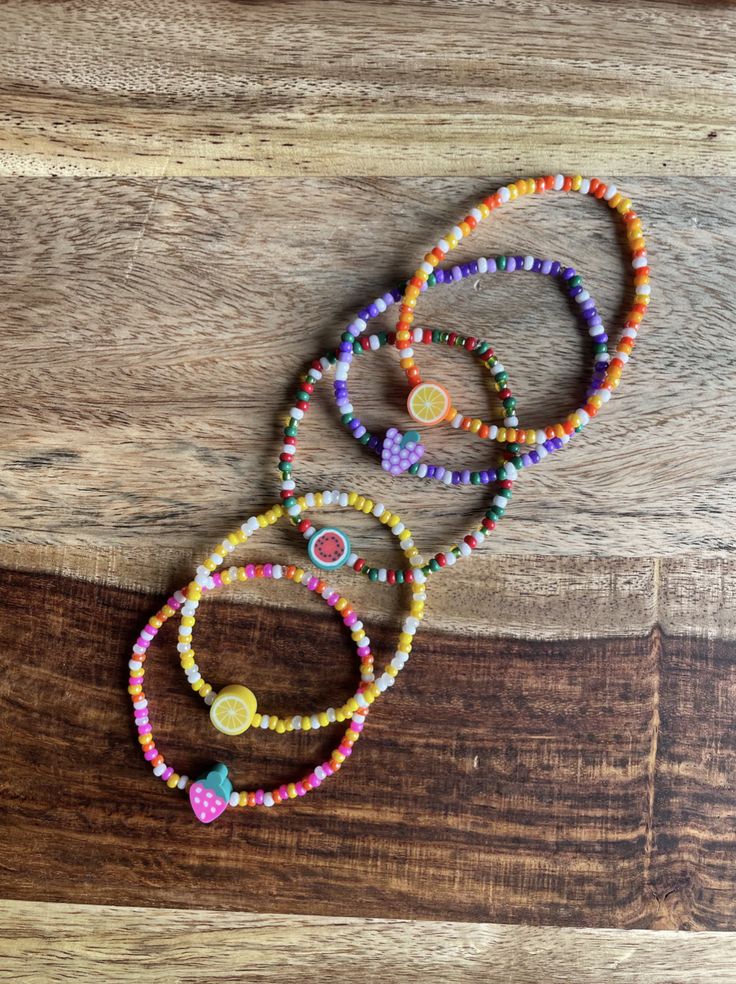 multicolored beaded bracelets on wooden surface