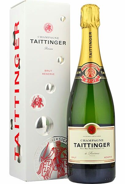 a bottle of tattinger champagne next to a box