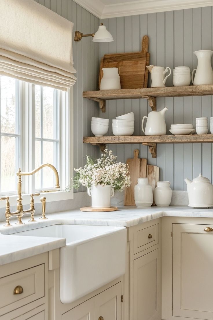 a kitchen filled with lots of white dishes and vases on top of wooden shelves