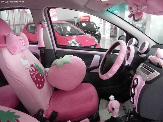 the interior of a car decorated in pink and green with hello kitty decorations on it