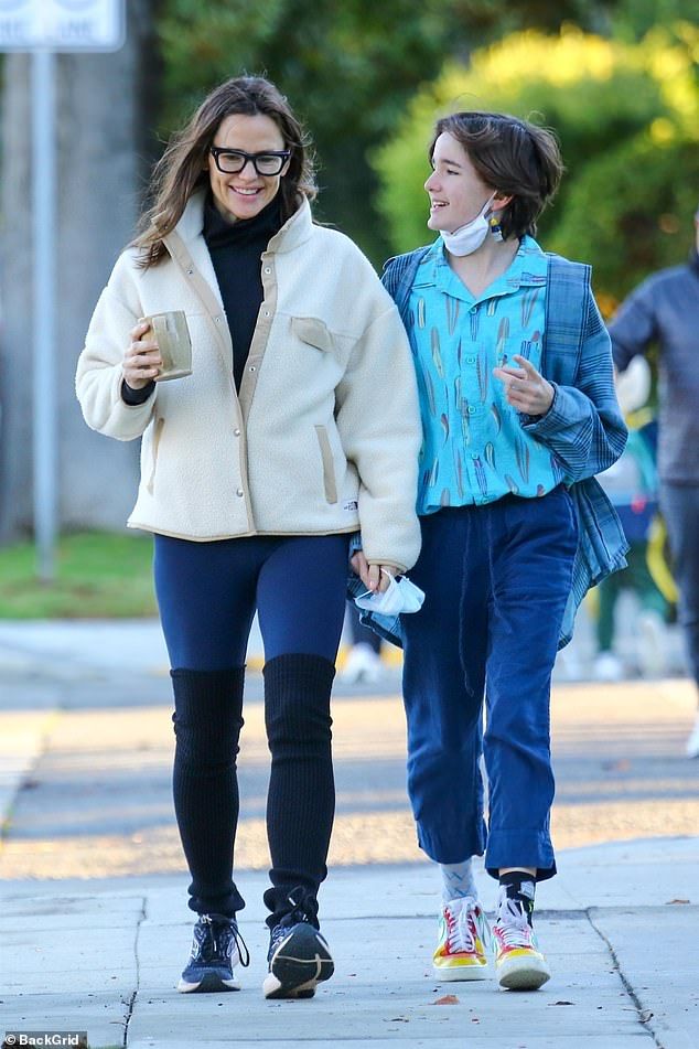 two women walking down the street together