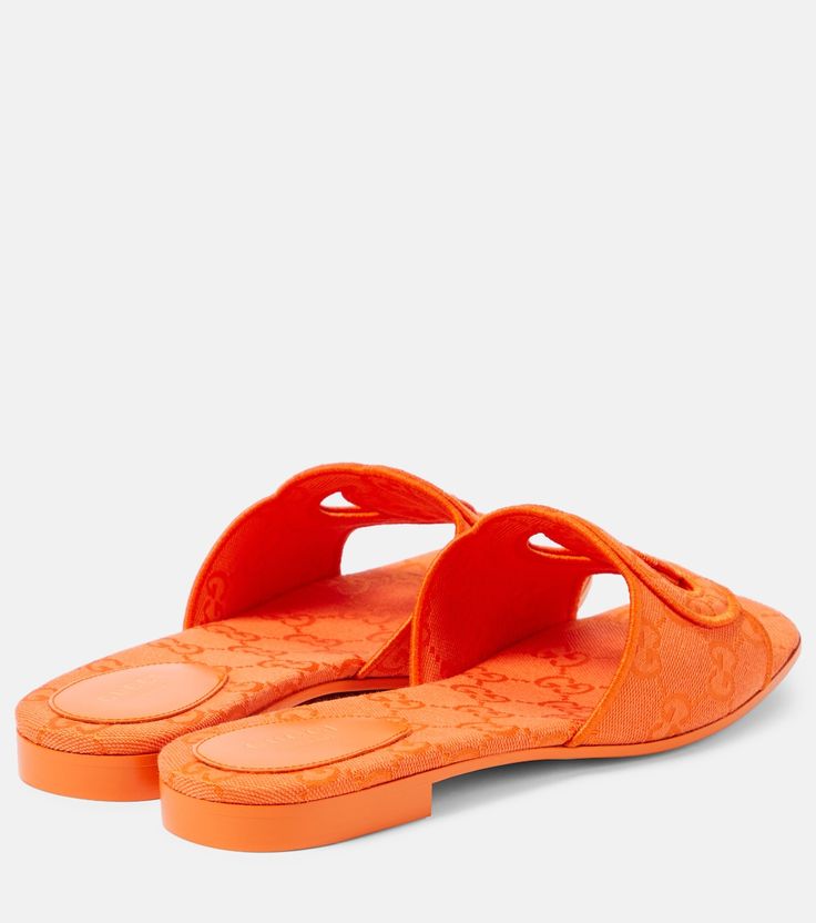 GG canvas sandals in orange - Gucci | Mytheresa Gucci Luxury Open Toe Mules, Gucci Luxury Sandals For Summer, Luxury Gucci Sandals For Summer, Designer Open Toe Slides For Vacation, Gucci Open Toe Leather Slides, Gucci Leather Open Toe Slides, Designer Summer Slides With Removable Insole, Designer Flat Slides For Summer, Designer Summer Flat Slides