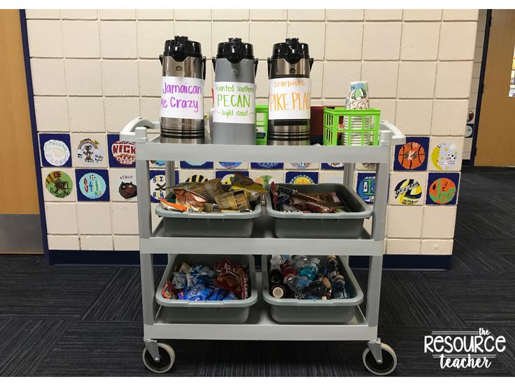 a cart with three bins on it in front of a white wall and blue carpet