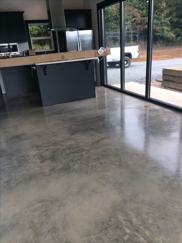 an empty kitchen with large sliding glass doors