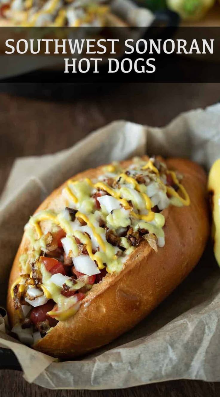 a hot dog sitting on top of a bun covered in toppings