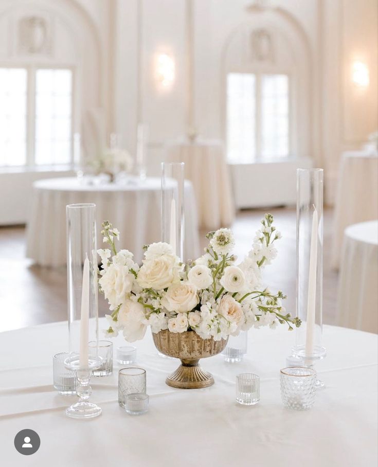 the centerpieces are arranged in vases and candles