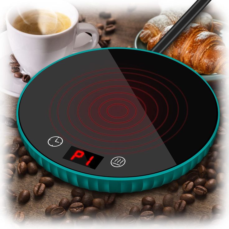 an electronic stove top with coffee beans and croissants in the background