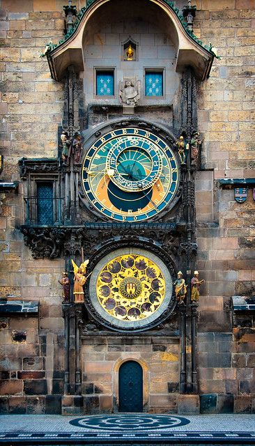 an old building with two clocks on the front and back of it's face