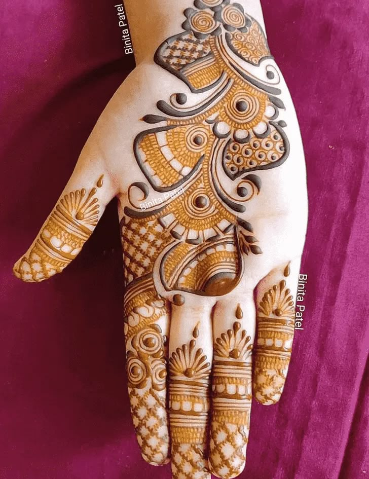 a woman's hand with henna tattoos on it