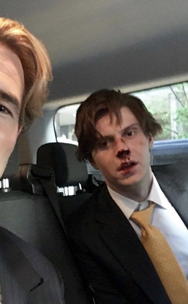 two men in suits and ties are sitting in the back seat of a car with their mouths open