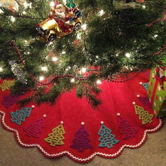 a christmas tree skirt with ornaments on it