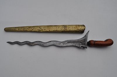 an old pair of scissors and a knife on a white surface with a wooden handle