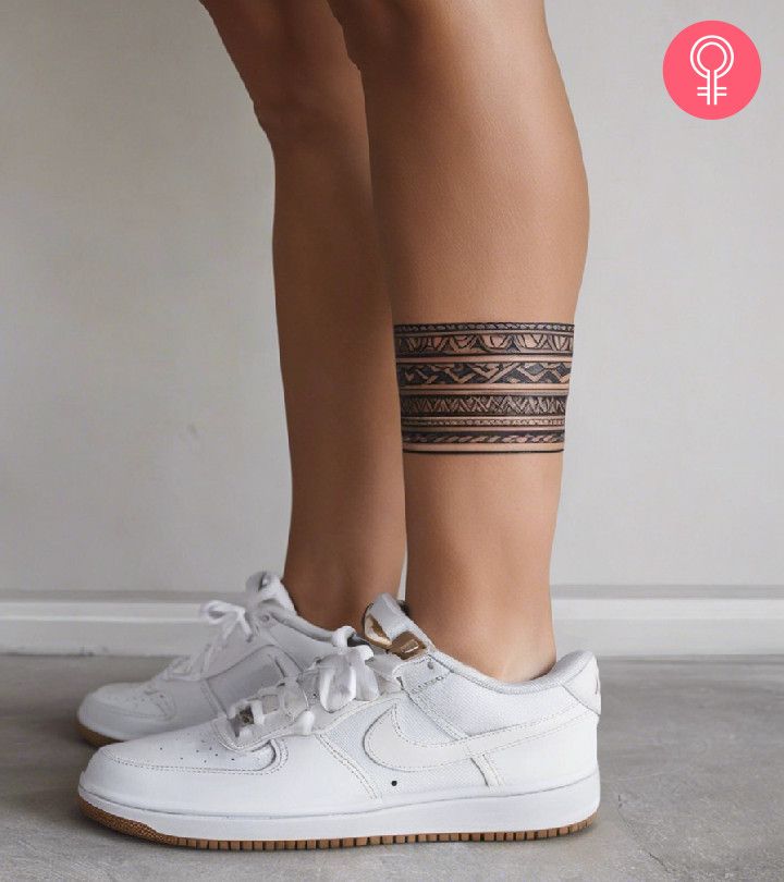 a woman's legs with a tattoo on her left leg and white nike air force sneakers