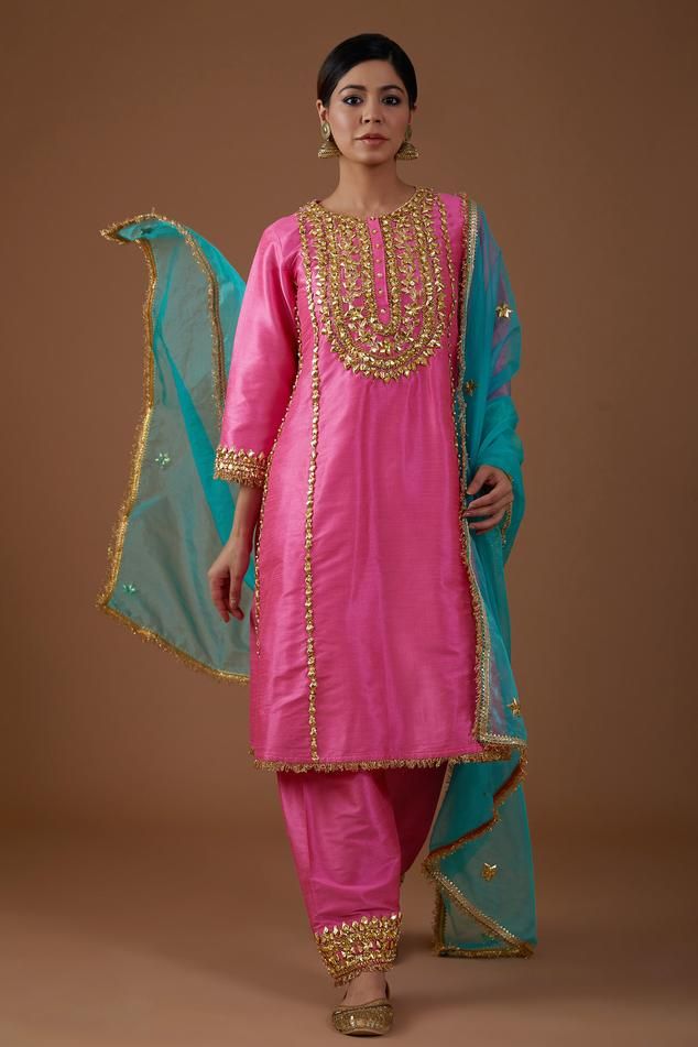 Electric pink A-line kurta with gota, sequins and pearls hand embroidery. Comes with salwar and a teal serenade dupatta. Components: 3 Pattern: Hand embroidered Type Of Work: Gota, Sequins, Pearls Neckline: Round Sleeve Type: Three quarter Fabric: Dupion silk, Dupatta : Organza Color: Pink Other Details:  Model Height : 5 ft 7 inches, wearing size M Closure : Kurta - Front buttons Occasion: Sangeet - Aza Fashions Dholki Dress, Hand Embroidery Designs For Suits, Salwar Embroidery, Long Kurti Patterns, Pakistani Fancy Dresses, Pakistani Fashion Party Wear, A Line Kurta, Designer Party Wear Dresses, Embroidery Suits Design