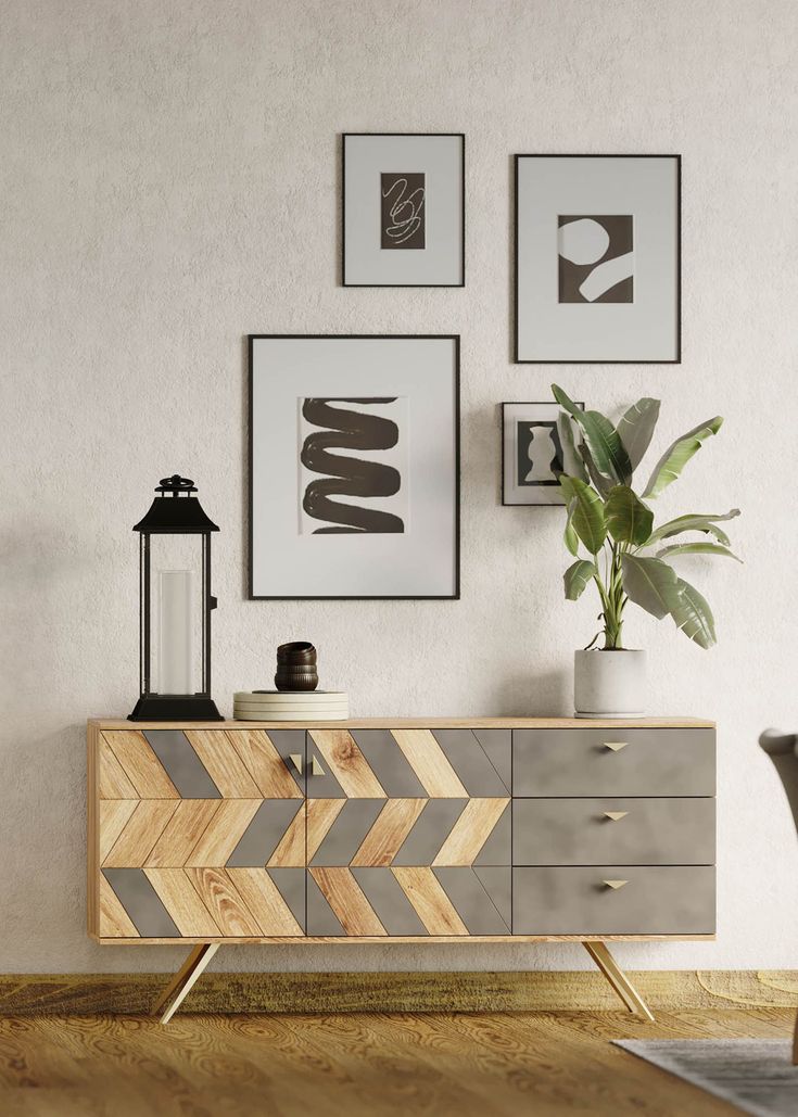 a living room with some pictures on the wall and a dresser in front of it