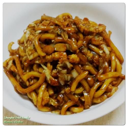 a white bowl filled with noodles covered in sauce