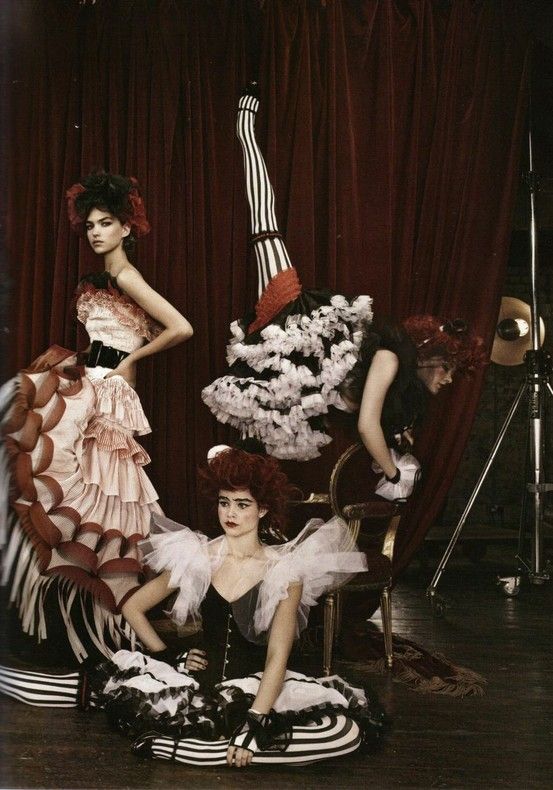 three women dressed in costumes posing for a photo