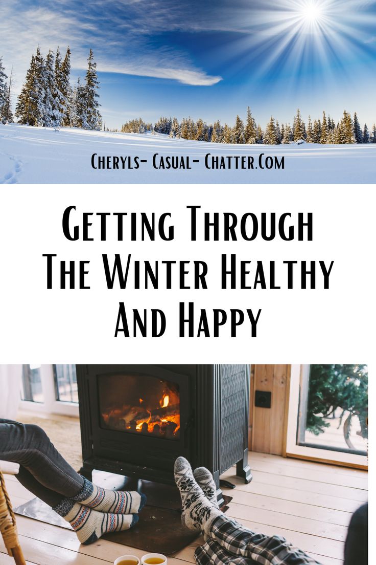 two people sitting in front of a fireplace with the words getting through the winter healthy and happy