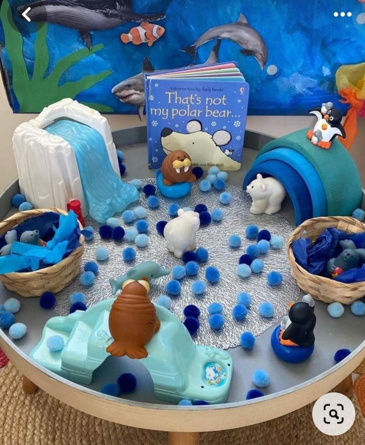 a table topped with lots of toys and books