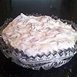 a pie sitting on top of a black table covered in frosting and icing