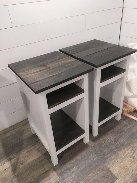 two wooden tables sitting next to each other on top of a hard wood floor in front of a white wall