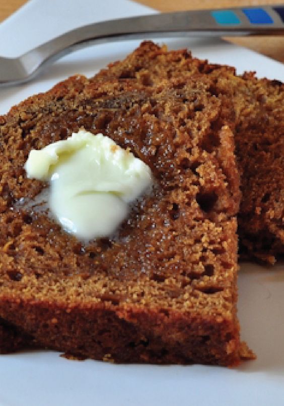 two pieces of bread on a plate with butter