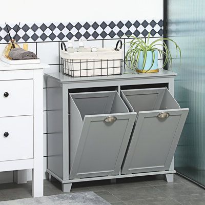 a gray cabinet with two bins on top of it next to a white sink