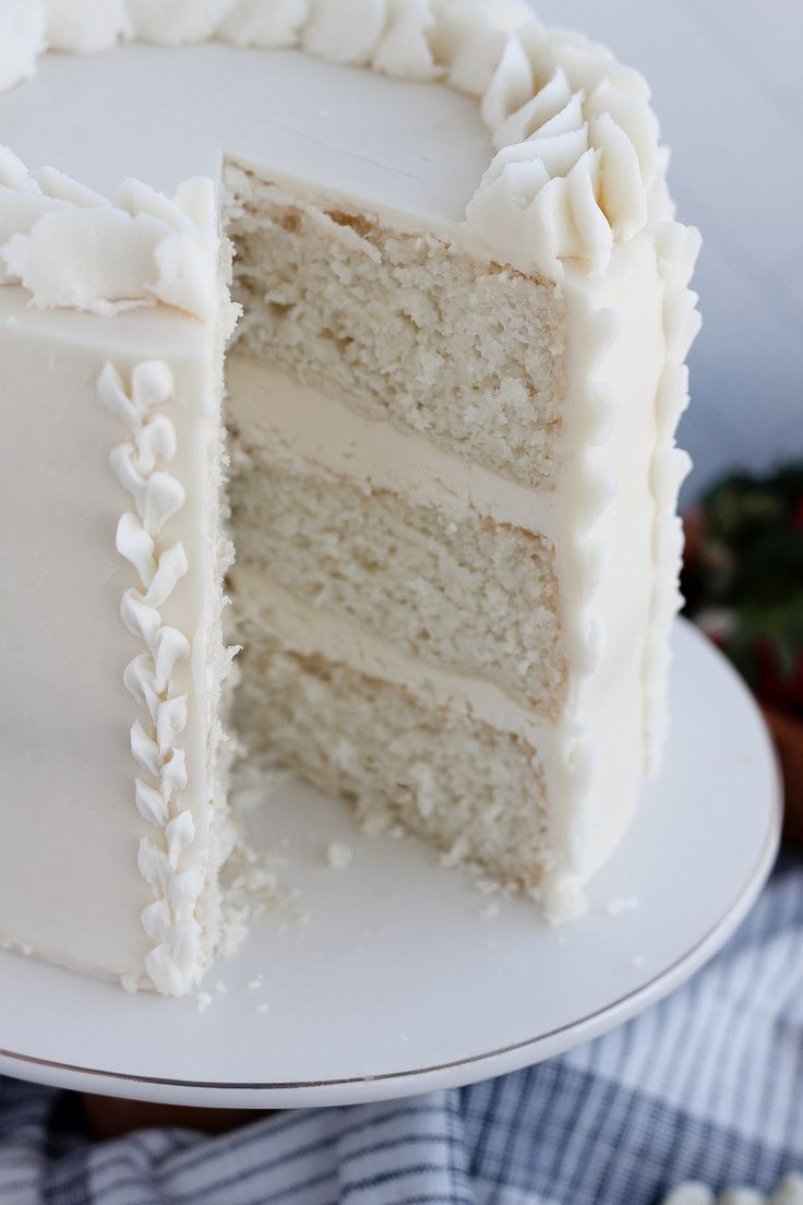 a slice is taken out of a white cake