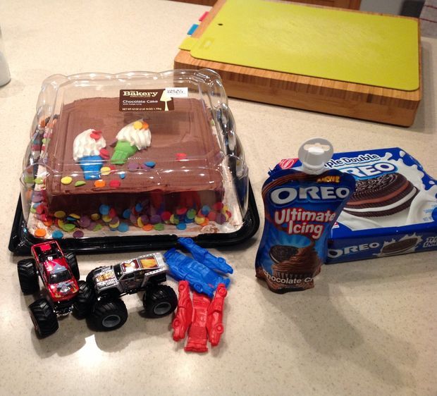 a table topped with cake and toys on top of it