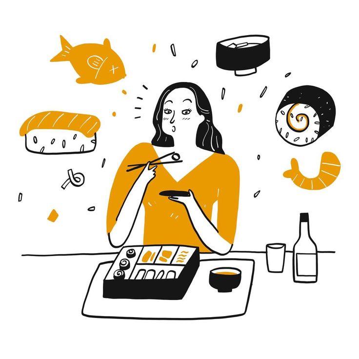 a woman eating sushi at the table with fish and other food items around her