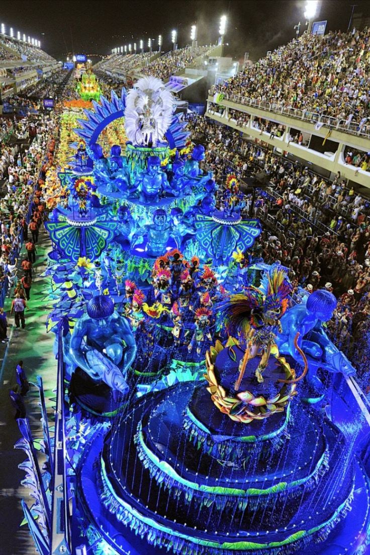 an elaborately decorated float in the middle of a stadium filled with people and spectators