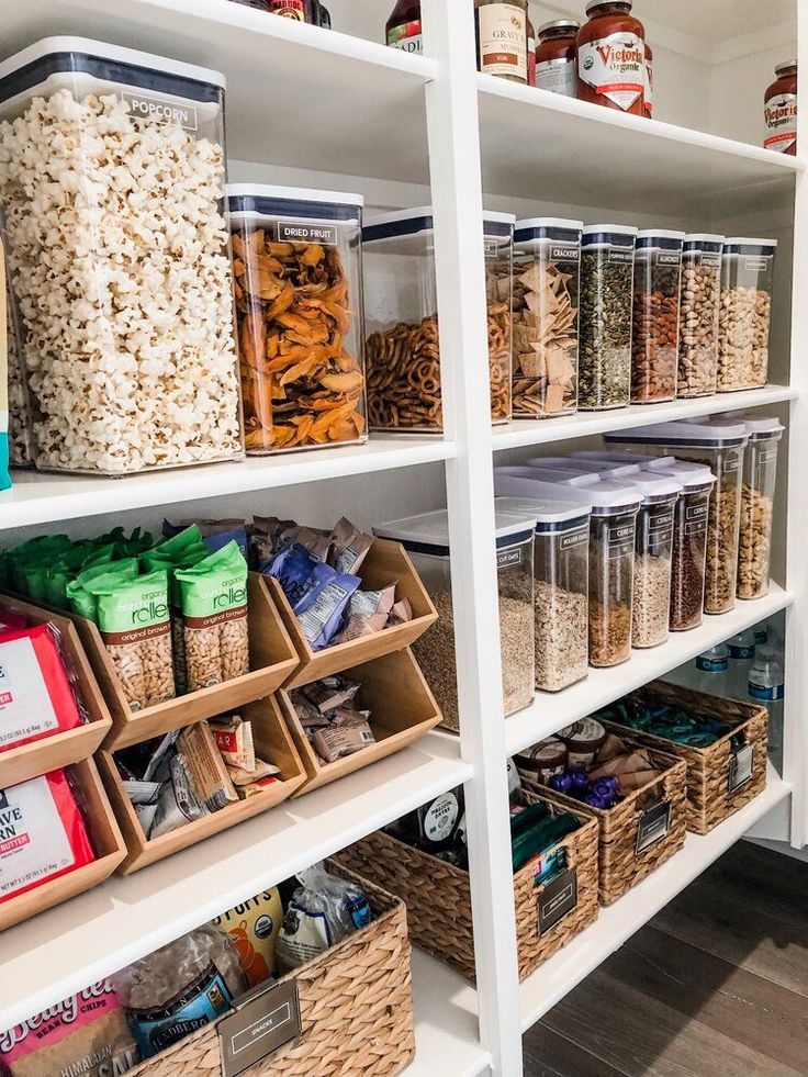 the shelves are filled with different types of food and containers on them, including popcorn