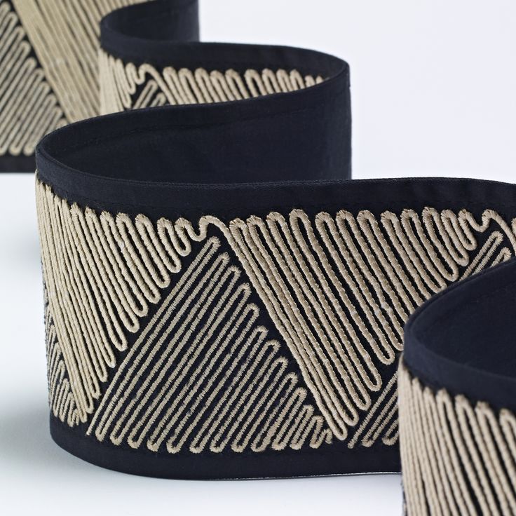 three black and white lampshades with gold lines on the top one is turned upside down