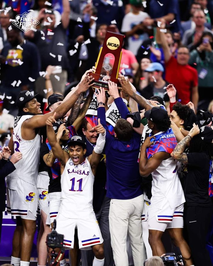 the men's basketball team is holding up their trophy and celebrating with confetti