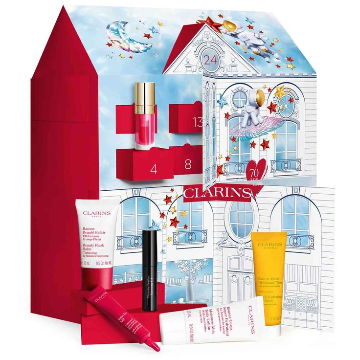 clarins christmas gift set with red box and white house in the background,