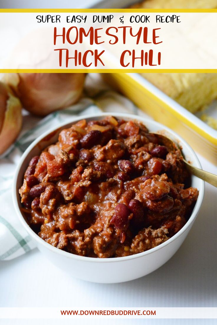 a white bowl filled with chili next to some onions and an onion on the side