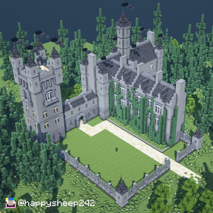 an aerial view of a large castle in the middle of some trees and grass area