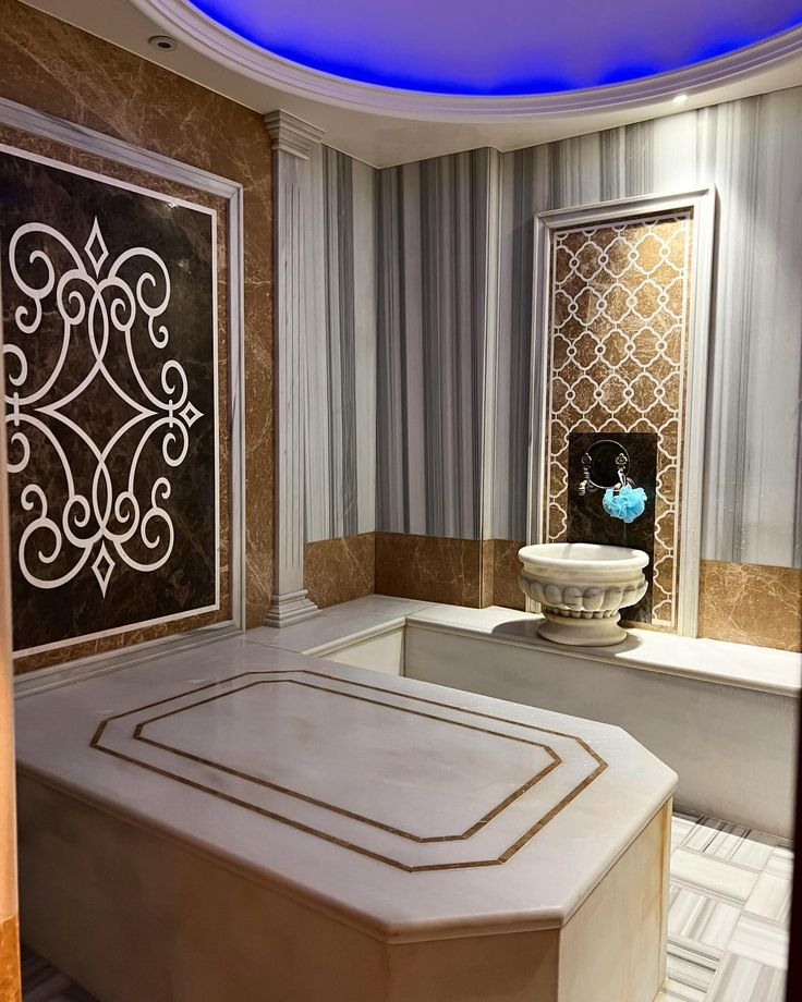 a bath room with a large tub and a blue light on the ceiling above it