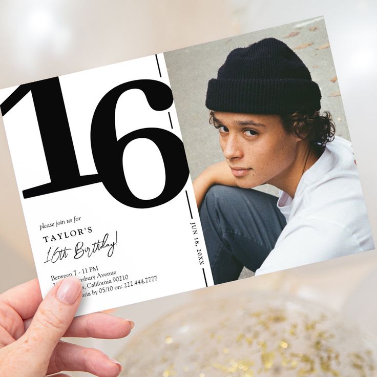 a person holding up a card with the number sixteen on it