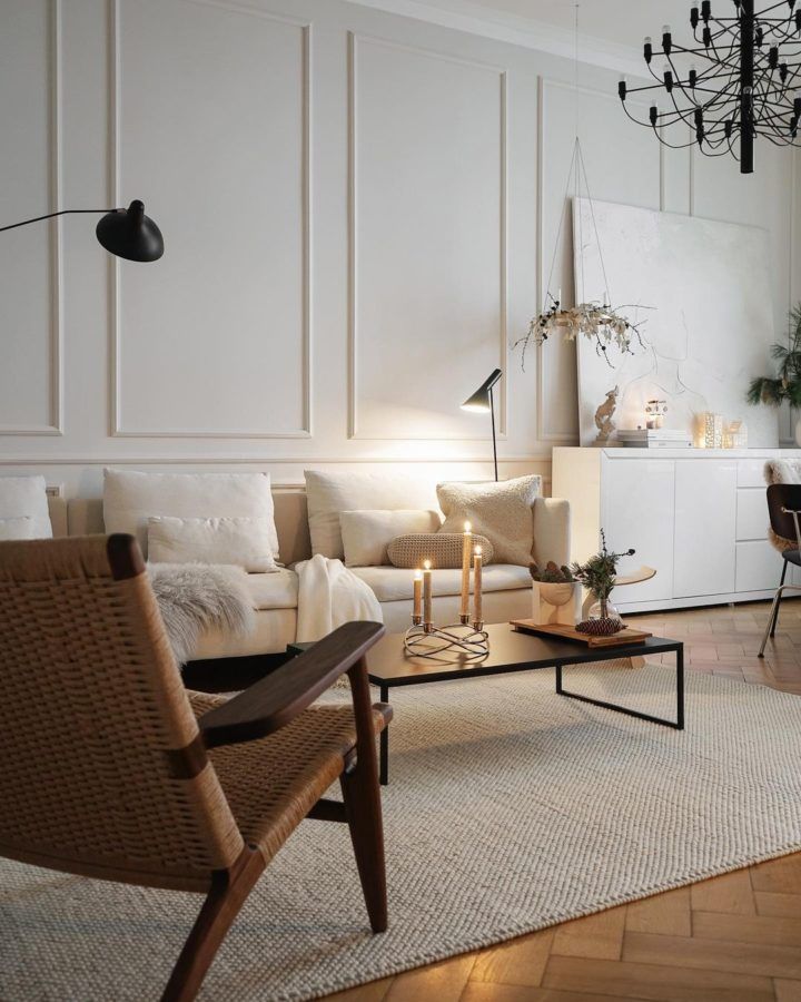 a living room filled with furniture and a chandelier