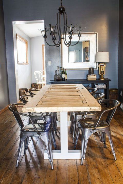 a dining room table with chairs and a chandelier hanging from it's ceiling