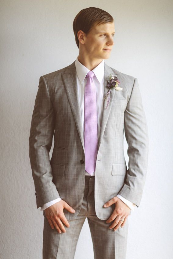 a man in a gray suit and pink tie