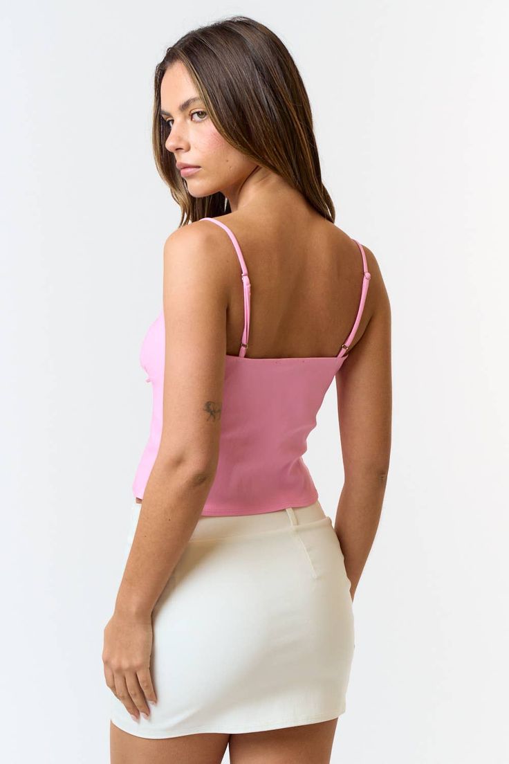 This pink front tie cami top is a total vibe! 😍 The soft pastel pink is perfect for brightening up your outfits, and the front tie detail adds that extra cute touch. With adjustable spaghetti straps and lightweight fabric, it's all about comfort and style. Pair it with your go-to high-waisted jeans or a flirty skirt for a look that's effortlessly chic. Whether you're heading to brunch or out with friends, this cami is your new go-to for a fresh, fun look! 🌟💖 Pink Tops With Built-in Bra For Day Out, Pink Fitted Crop Top With Spaghetti Straps, Trendy Camisole With Built-in Bra For Spring, Pink Spaghetti Strap Camisole With Built-in Bra, Feminine Spring Crop Top With Built-in Bra, Chic Fitted Pink Tank Top, Feminine Tops With Spaghetti Straps And Built-in Bra, Pink Cami Tank Top With Built-in Bra, Fitted Pink Cami Crop Top