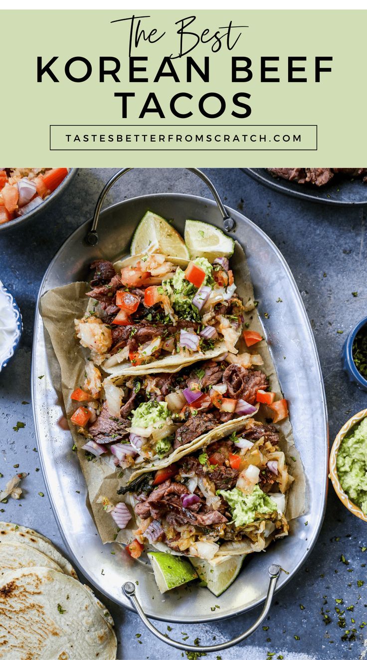 the best korean beef tacos on a platter with guacamole and salsa