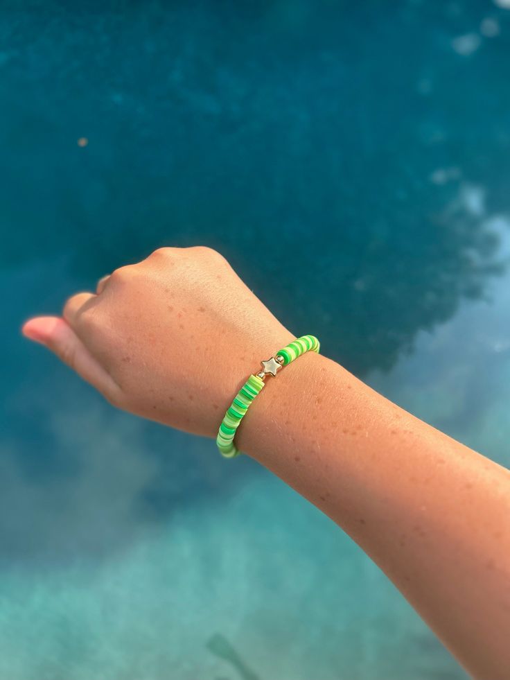 Add a burst of vibrant energy to your look with this neon green beaded bracelet! Each handcrafted clay bead radiates a brilliant neon green, bringing a lively and fresh vibe to any outfit. The smooth, matte finish of the beads gives the bracelet a chic and modern appeal, while the stretchy band ensures a comfortable and secure fit on any wrist. Green Friendship Bracelets With Colorful Beads For Vacation, Green Beaded Friendship Bracelet For Vacation, Green Round Beads Friendship Bracelets For Summer, Summer Friendship Bracelets With Green Round Beads, Trendy Green Beaded Bracelets For Friendship, Green Friendship Bracelets With Round Beads For Vacation, Green Round Beads Friendship Bracelet, Summer Green Friendship Bracelets With Colorful Beads, Green Summer Friendship Bracelets With Colorful Beads