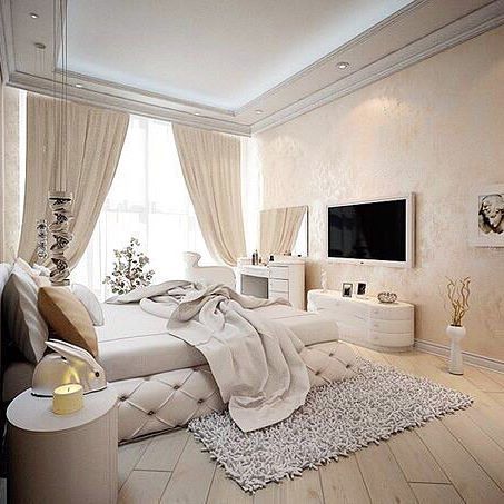 a bedroom with white furniture and curtains on the windowsills is decorated in neutral tones