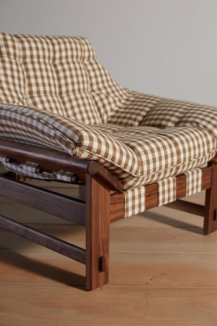 a brown and white checkered chair on wooden floor