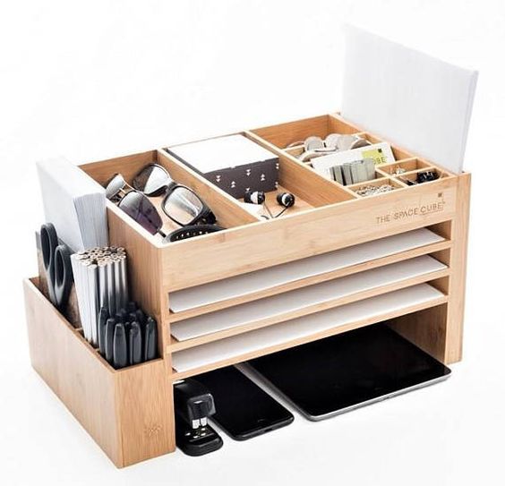 a wooden desk organizer filled with office supplies