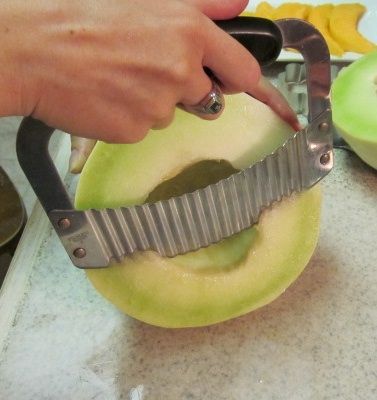 a person cutting an apple with a knife