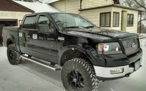 a black truck parked in front of a house